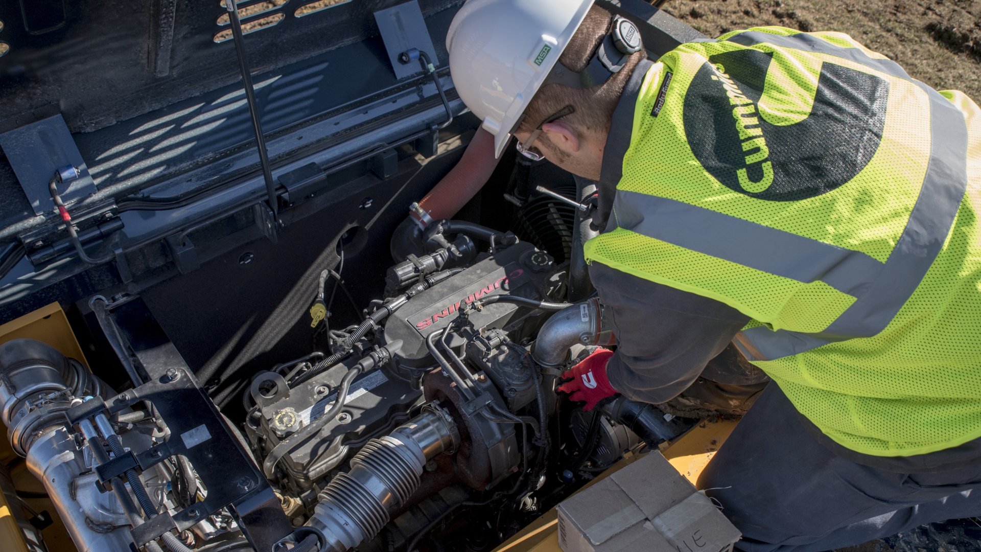 service technician working on engine