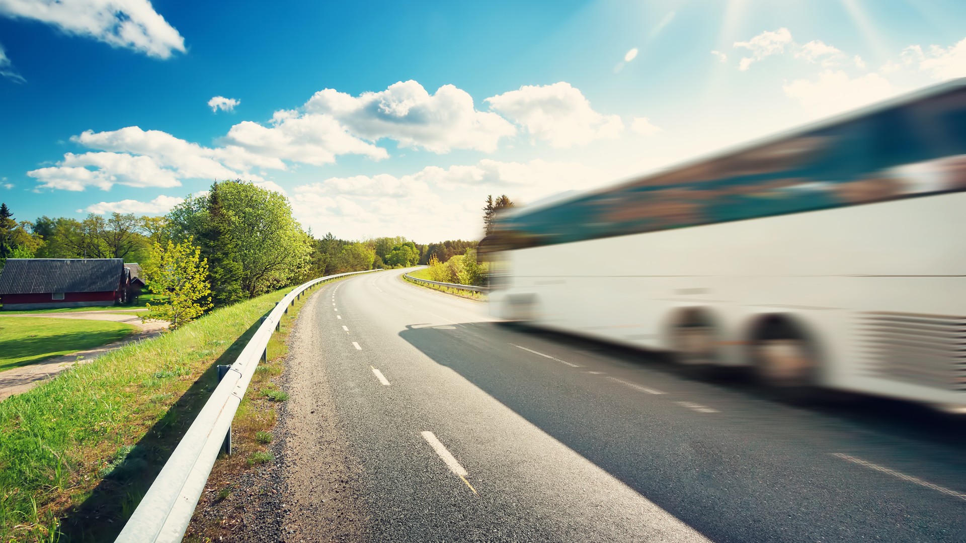 White bus driving on a highway