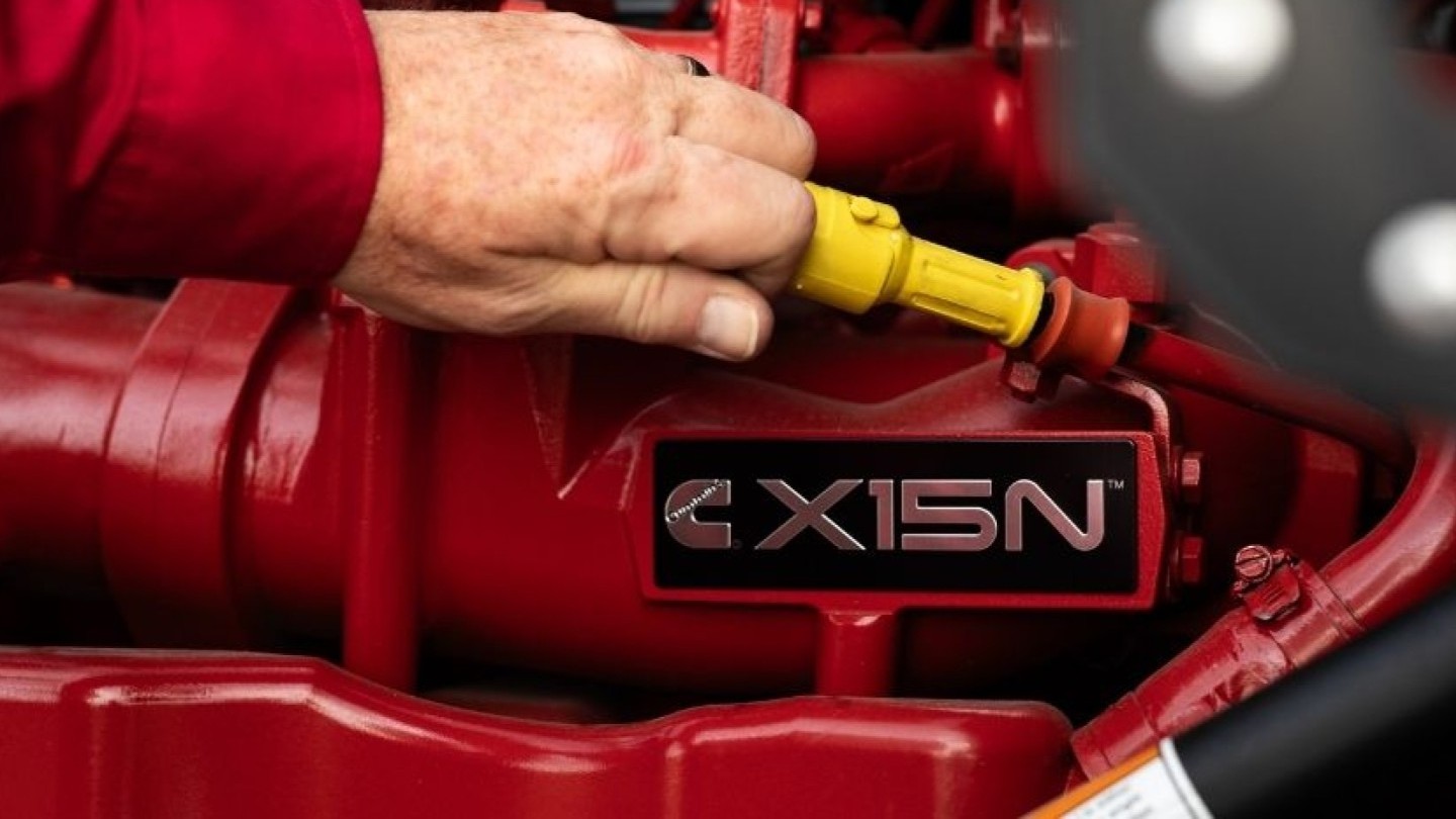 hand grabbing oil stick from natural gas engine