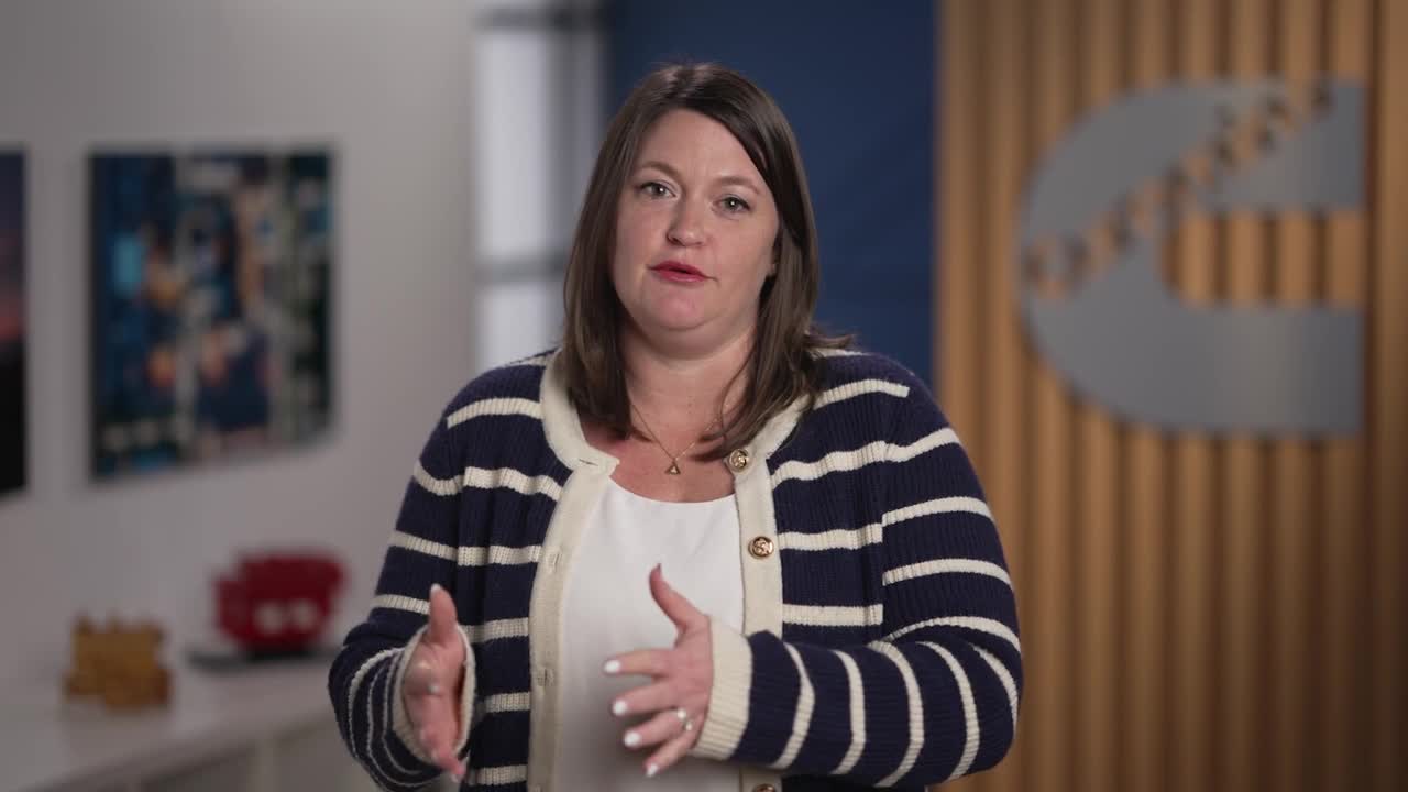 Molly Puga speaking in an office environment with Cummins branding