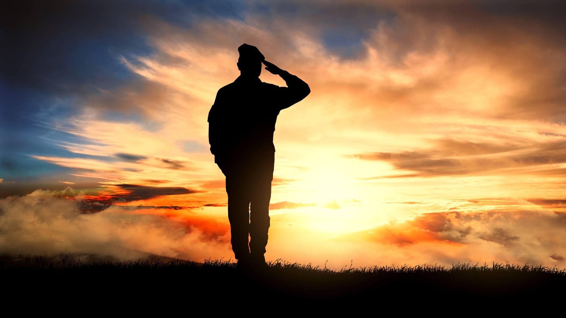 Soldier saluting towards the sun set
