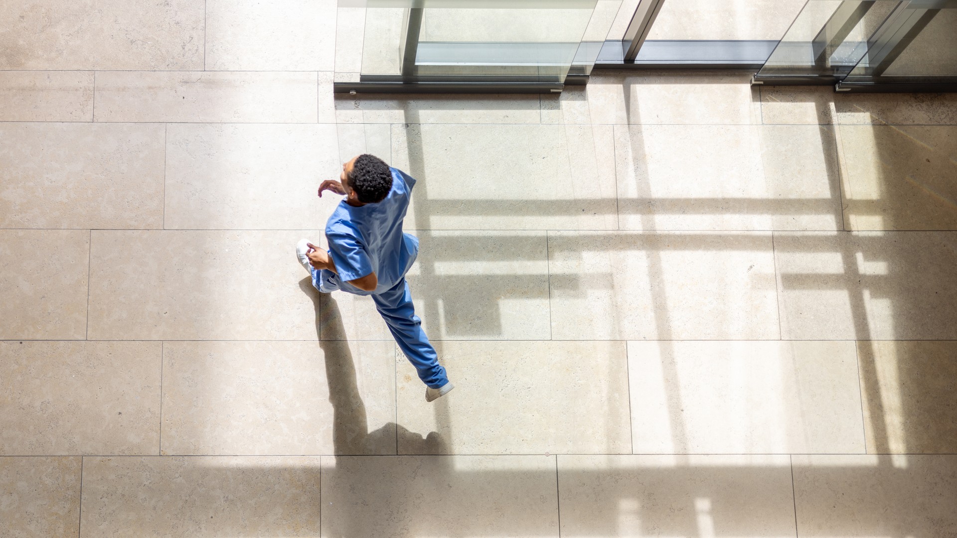 Healthcare worker running inside building