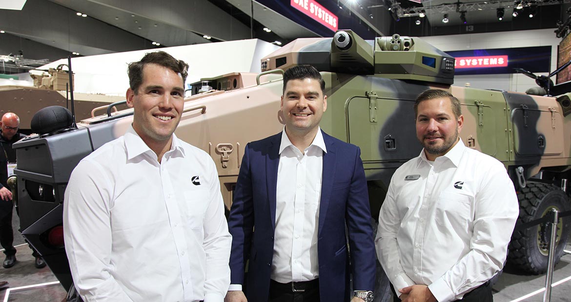 Employees standing in front of ATLAS