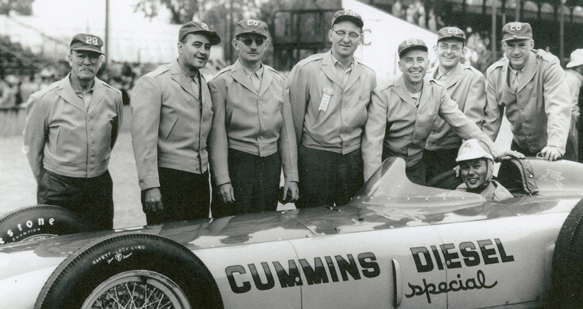 1952 Cummins Diesel Special racing team; Don Cummins is third from right with driver Freddie Agabashian sitting in the car