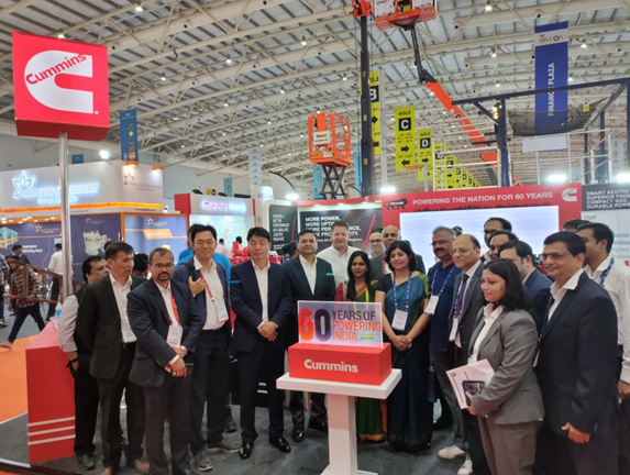 Anjali Pandey unveiling the 60 Years of Powering India logo at the Cummins India stall at EXCON 2022