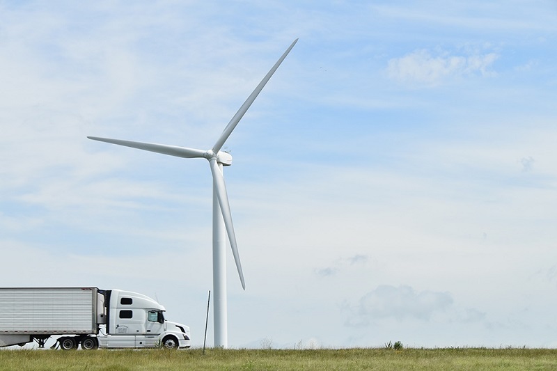 Truck drives by a turbine at Meadow Lake