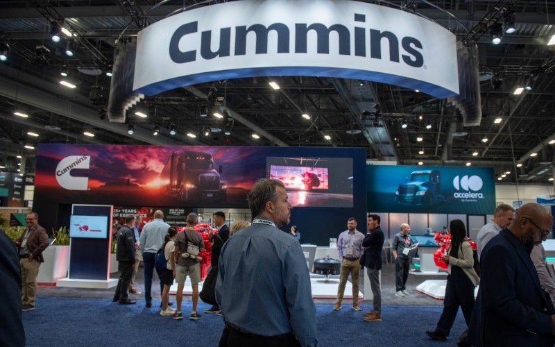Person standing in front of the Cummins booth at the Las Vegas convention center