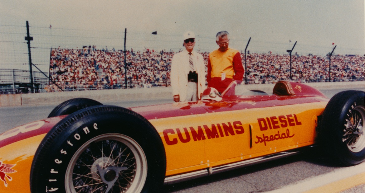 Don cummins with Freddie Agabashian in front of the Cummins Diesel Special race car crica the early 1970s