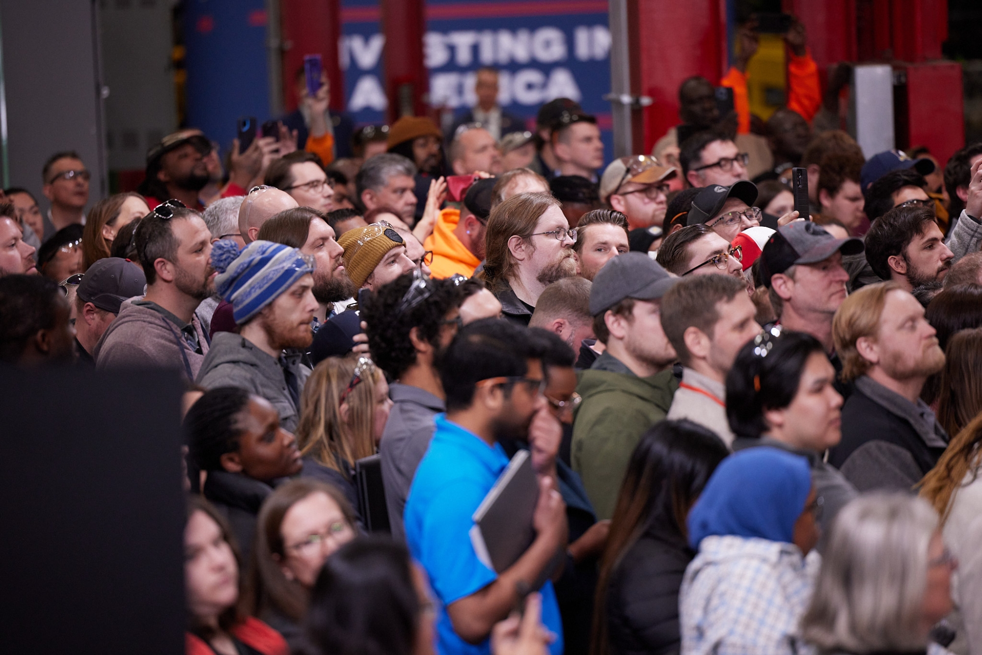 Employees watching President Biden speak