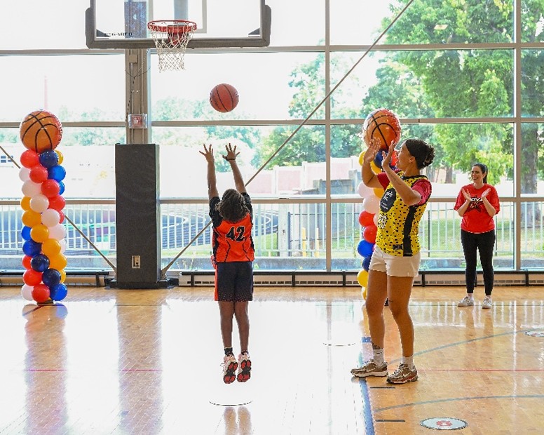 A participating student shoots a basket during the NBA Math Hoops LIVE segment of the STEM event