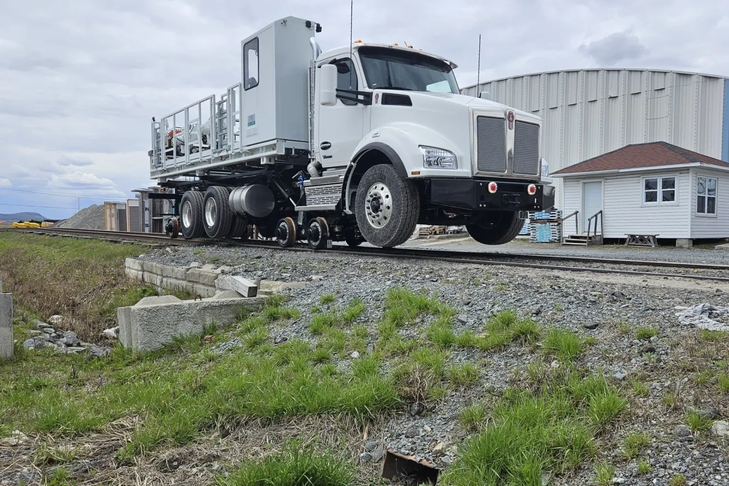 Customized road-rail service truck traveling on railroad tracks as part of a rail maintenance and infrastructure support solutionCustomized road-rail service truck traveling on railroad tracks as part of a rail maintenance and infrastructure support solution