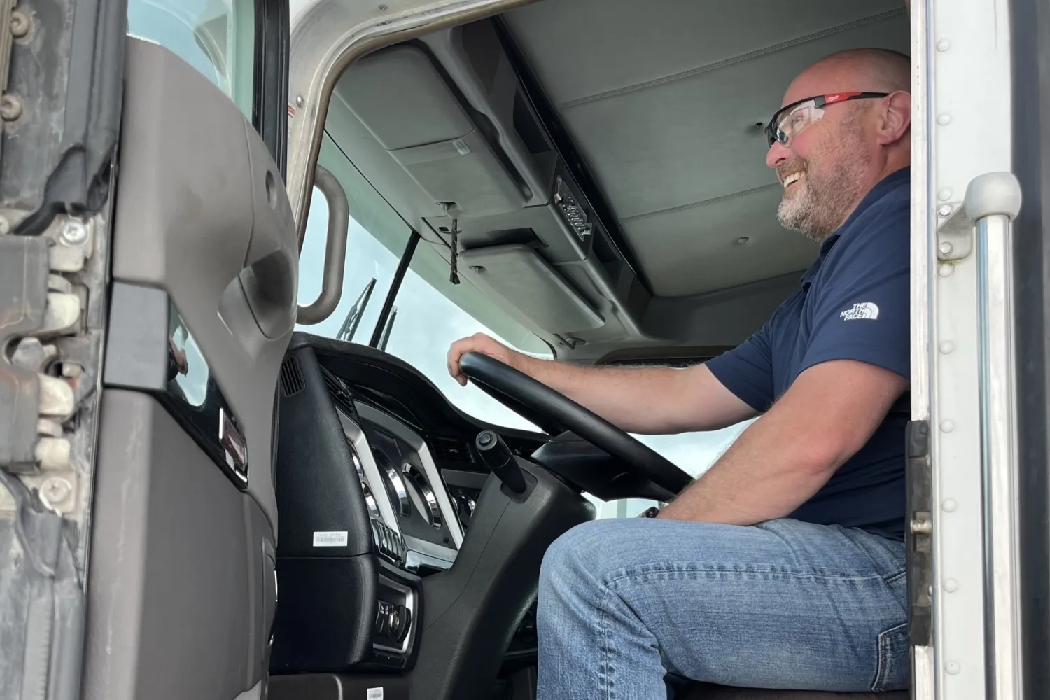 Reggie Witt in vocational truck cab with door open