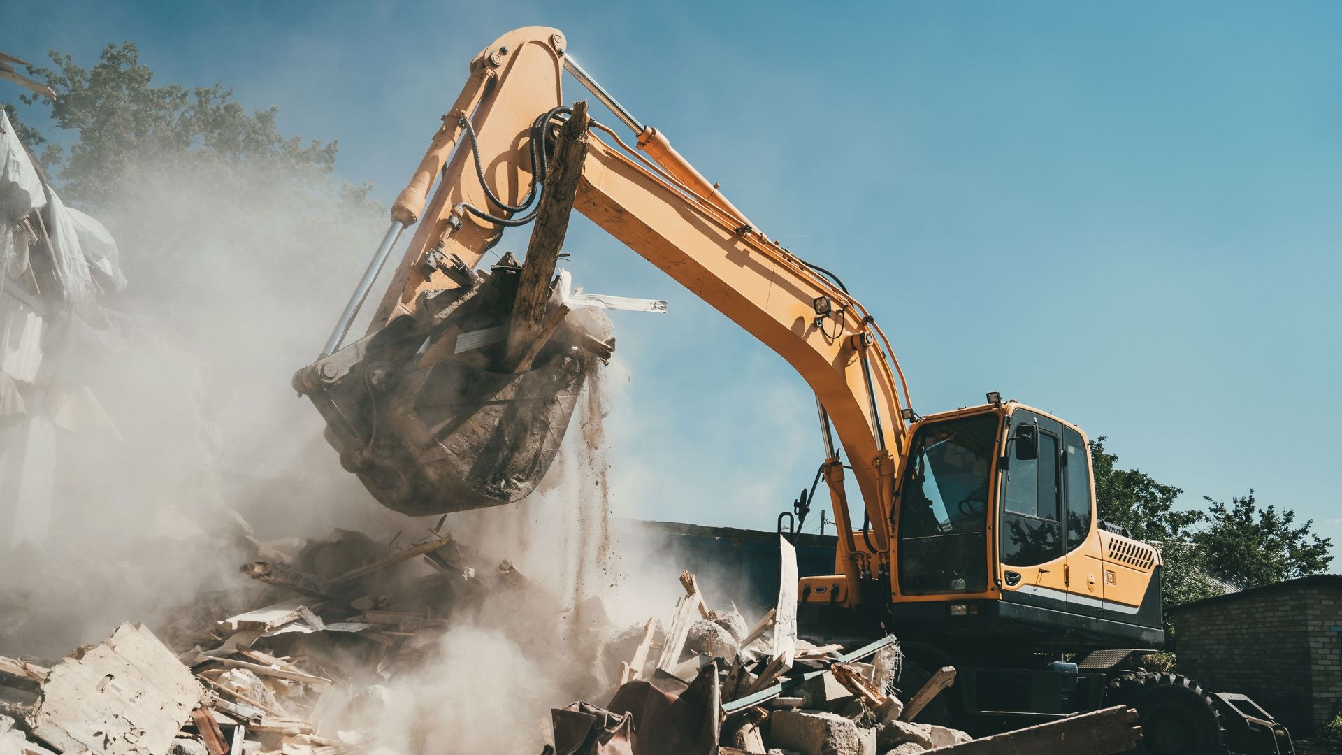 tractor demolishing structure on construction site