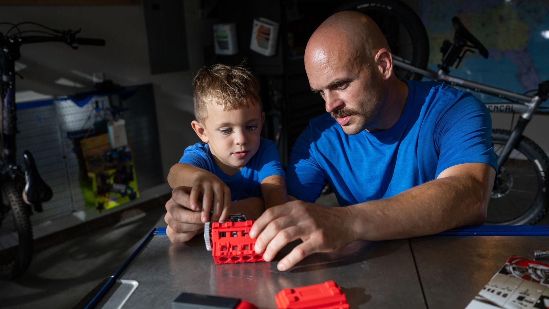 Cummins PowerGen field service technician assembling a toy engine with his son in a workshop