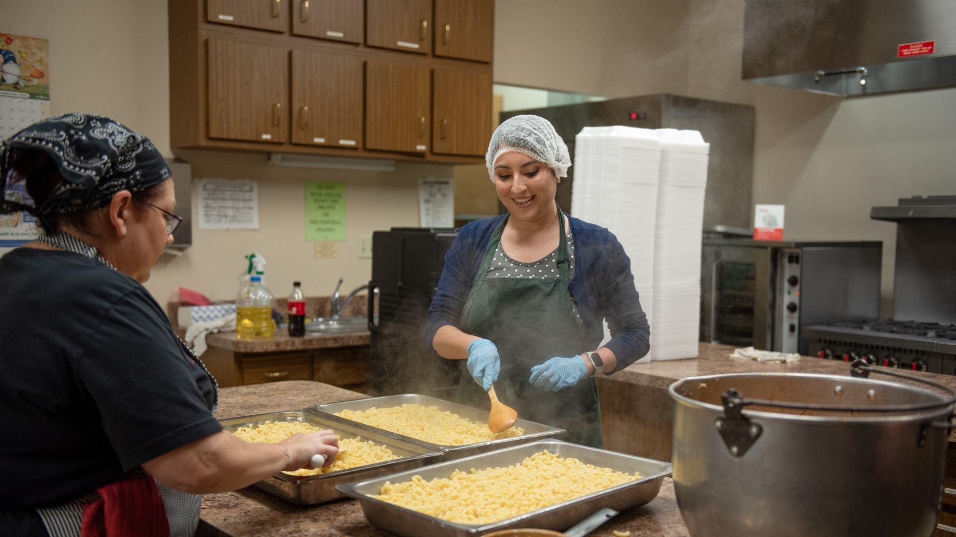 Amy Kriz packages meals with a Community Diner volunteer as part of her Cummins community engagement work.