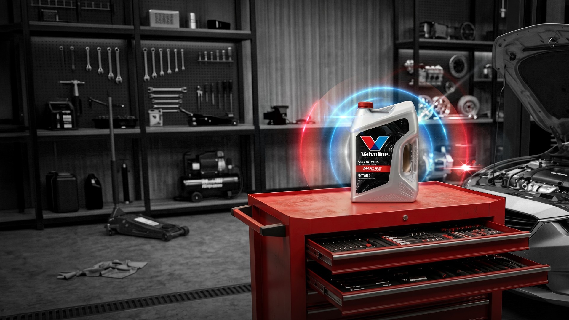 Valvoline motor oil container displayed on a red tool chest in an automotive workshop