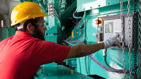 technician servicing diesel generator 