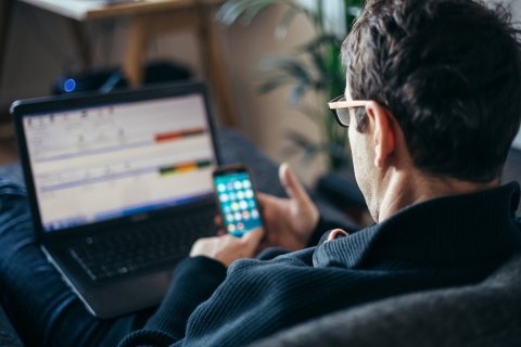 man looking at smart phone screen