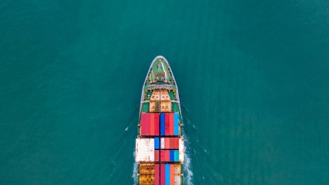 cargo ship moving through a large body of water