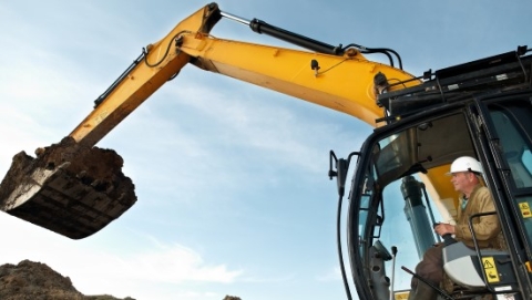 Construction worker using a digger