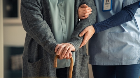 nurse assisting elderly patient
