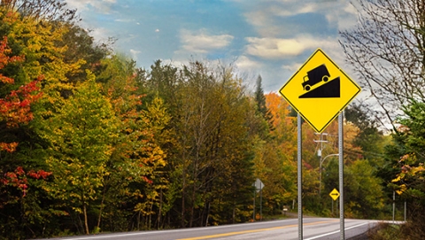 Hilly terrain with yellow sign