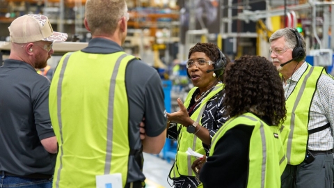 company leaders on ground floor of factory