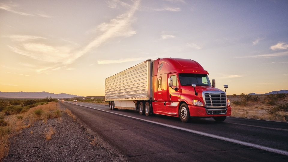 Red truck driving on highway