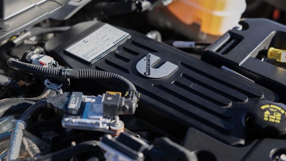Close-up of a Cummins engine compartment showing the engine cover and surrounding components