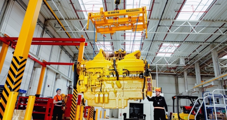 engine being hoisted up inside the rebuild center