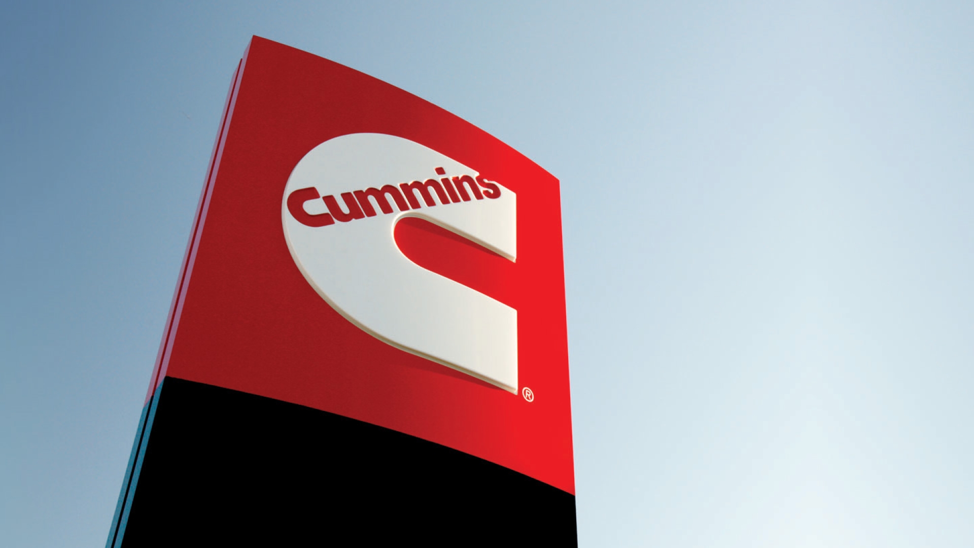 Cummins logo signage against a blue sky