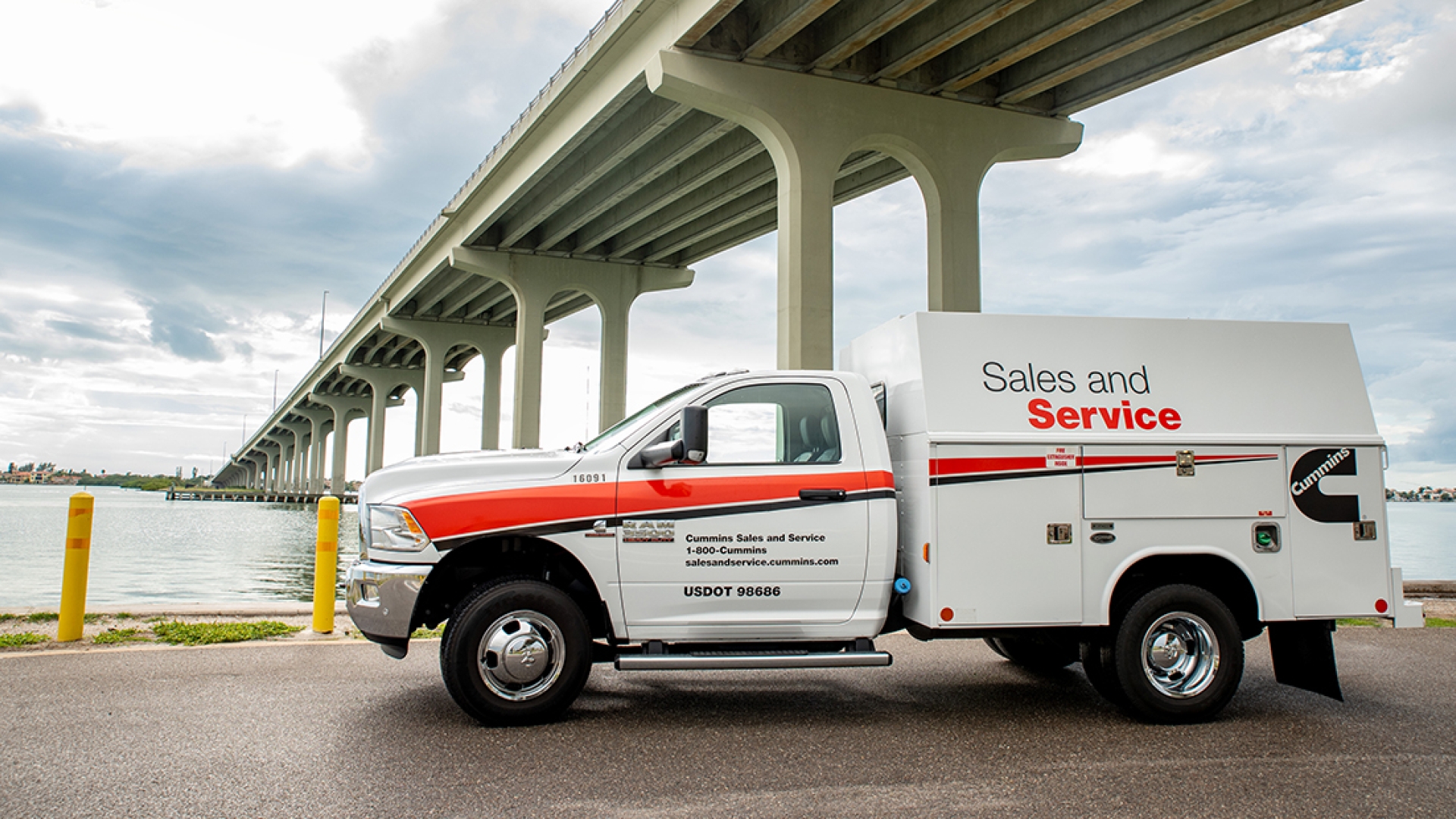 Sales and Service truck parked by bridge