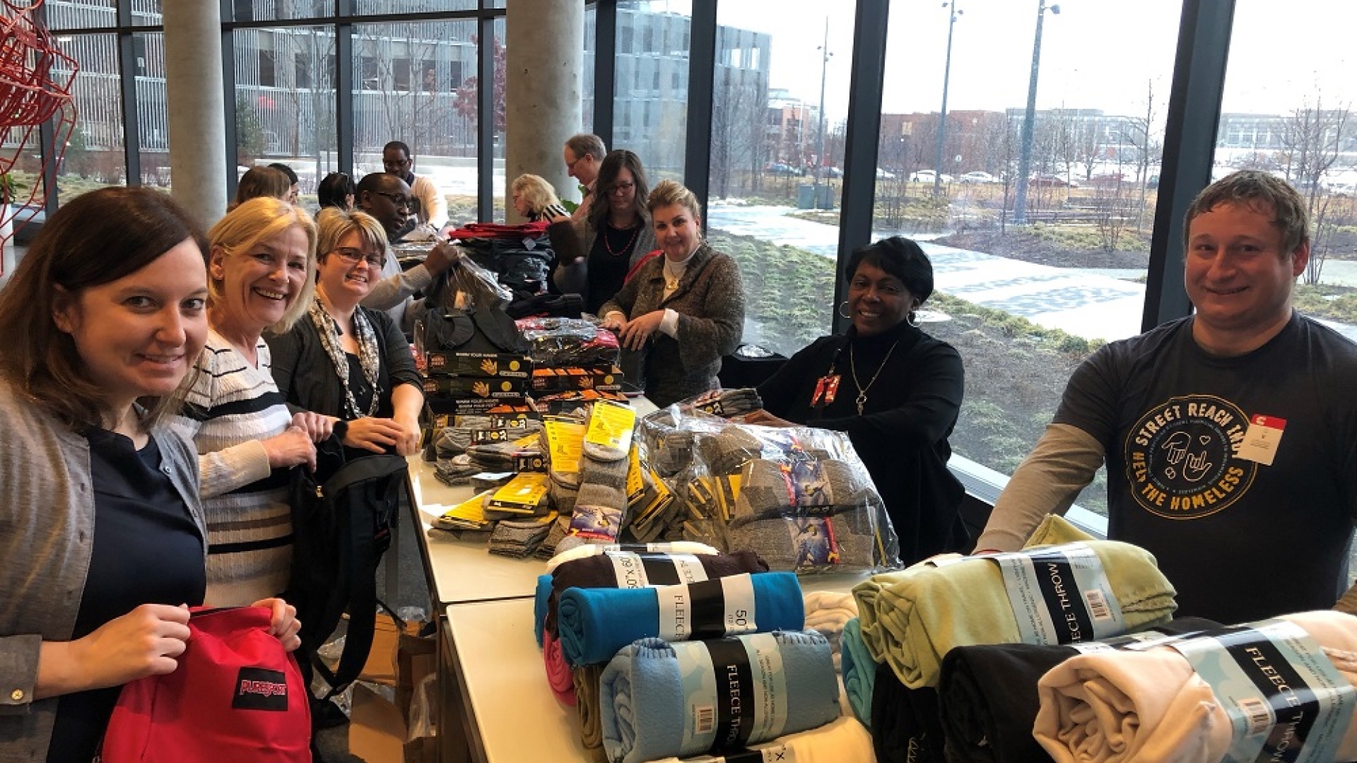 Volunteers assemble winter kits for the homeless in the lobby of Cummins’ Distribution Business Headquarters on the east side of Indianapolis.