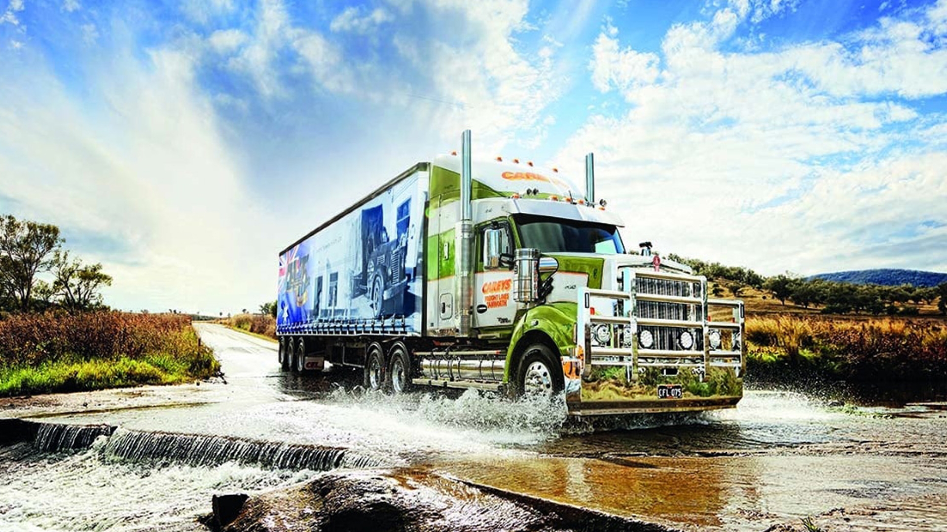 semi truck driving through water