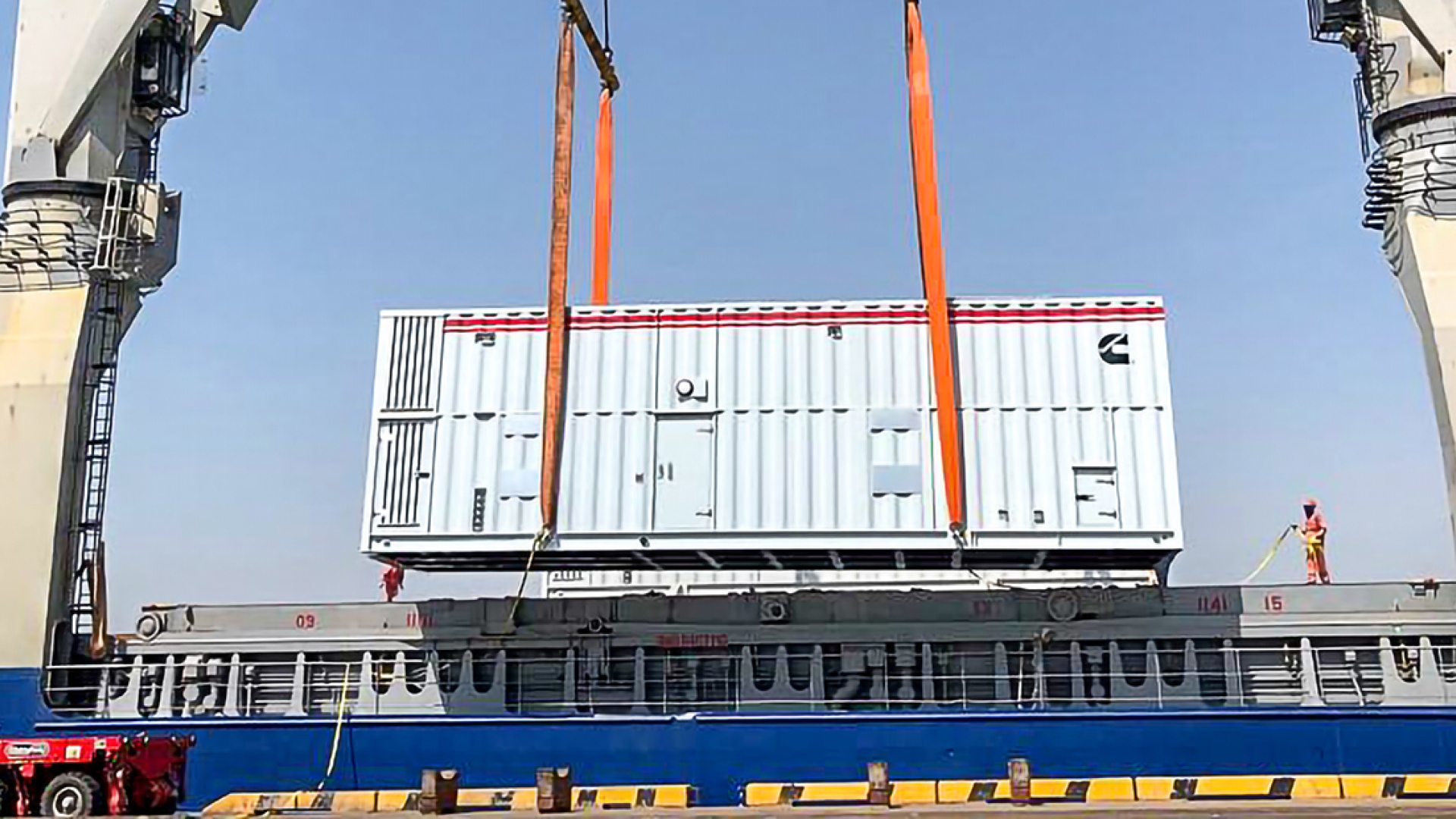 A Cummins C3000D5E generator in an acoustic enclosure is offloaded at the port.