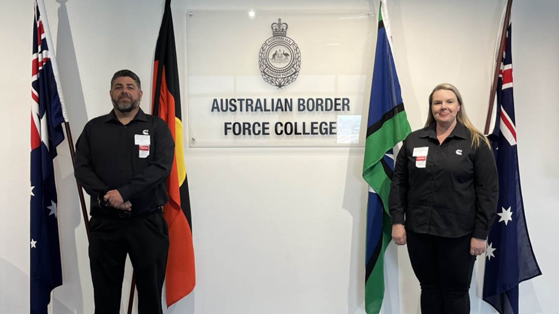 Employees standing by flags