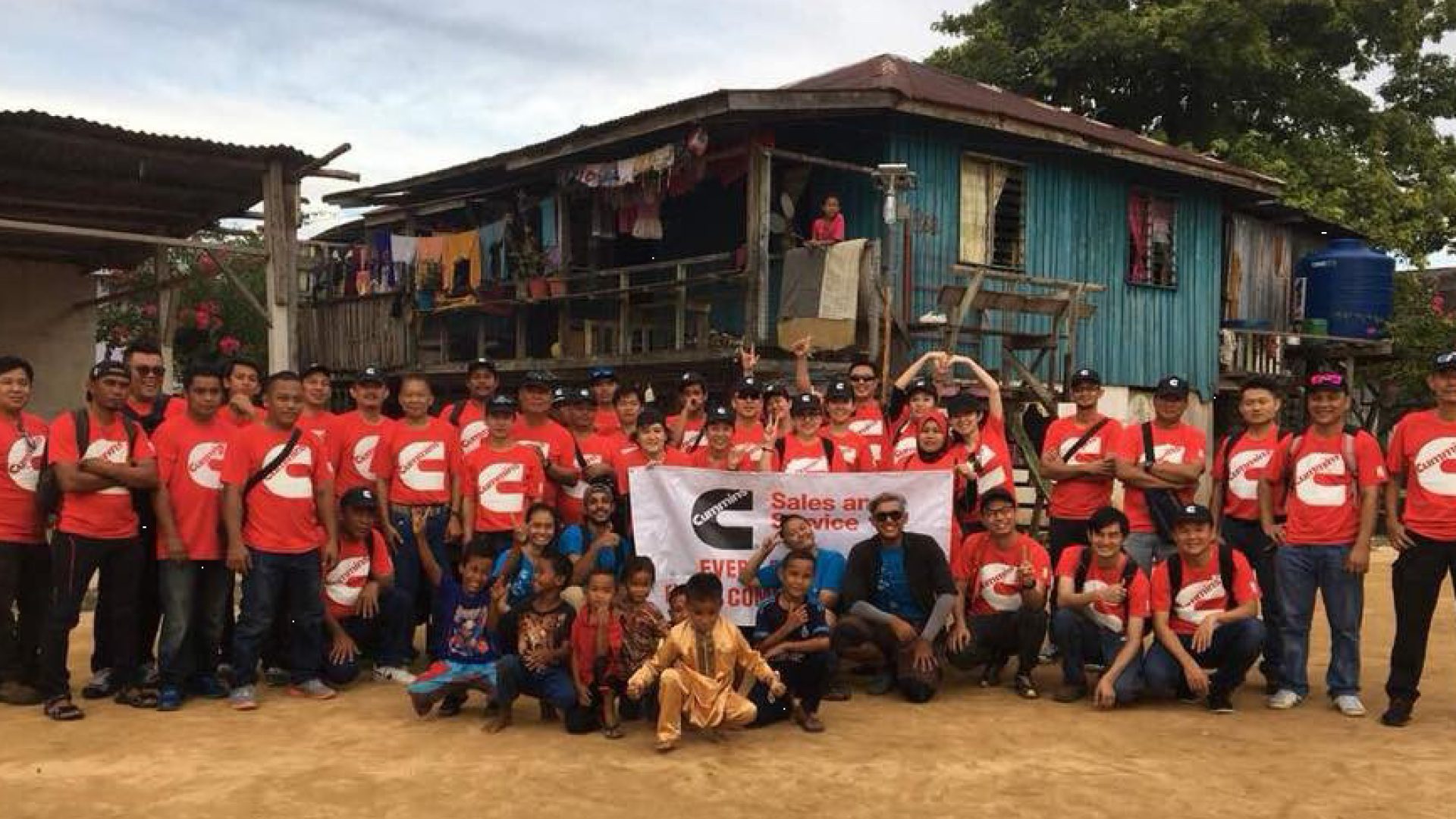 Cummins employees in Malaysia celebrate bringing solar lighting to a village without electricity.