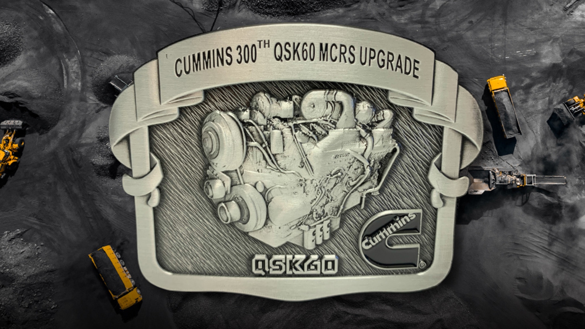 belt buckle with text reading "Cummins 300th QSK60 MCRS Upgrade"