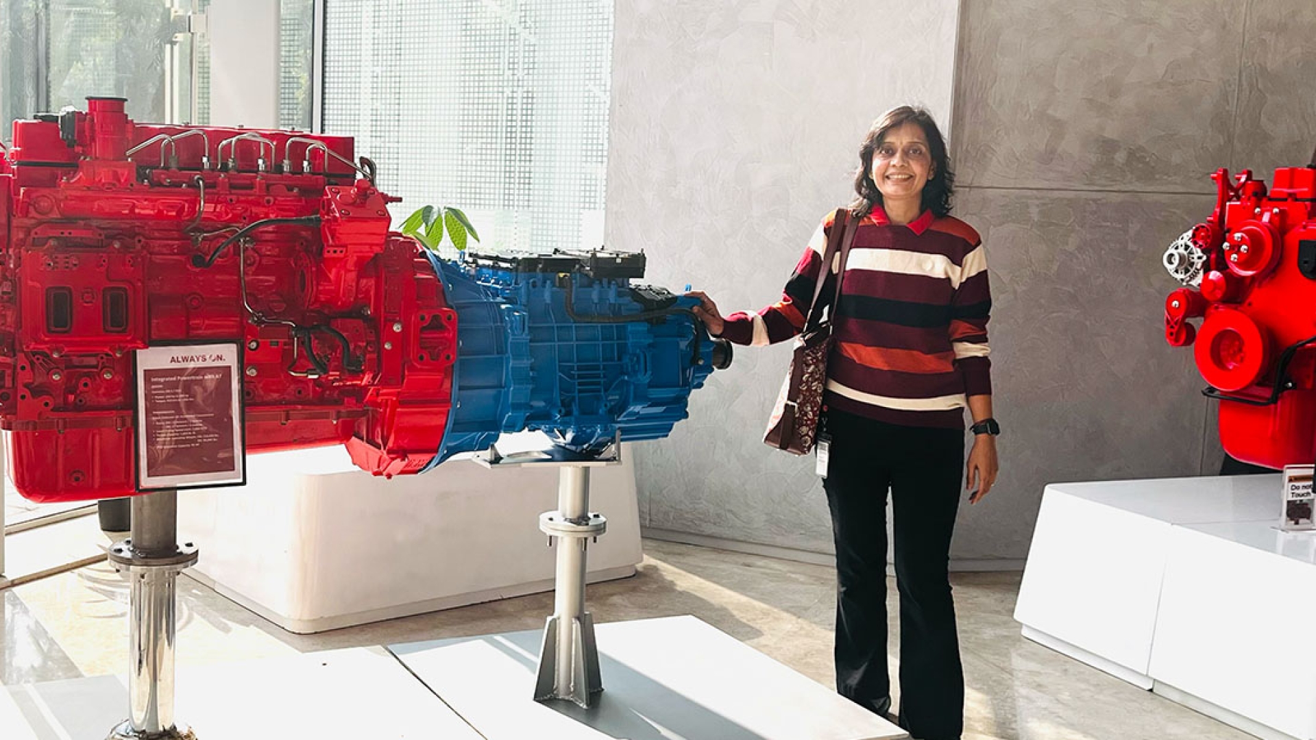 Employee standing next to engine prototypes