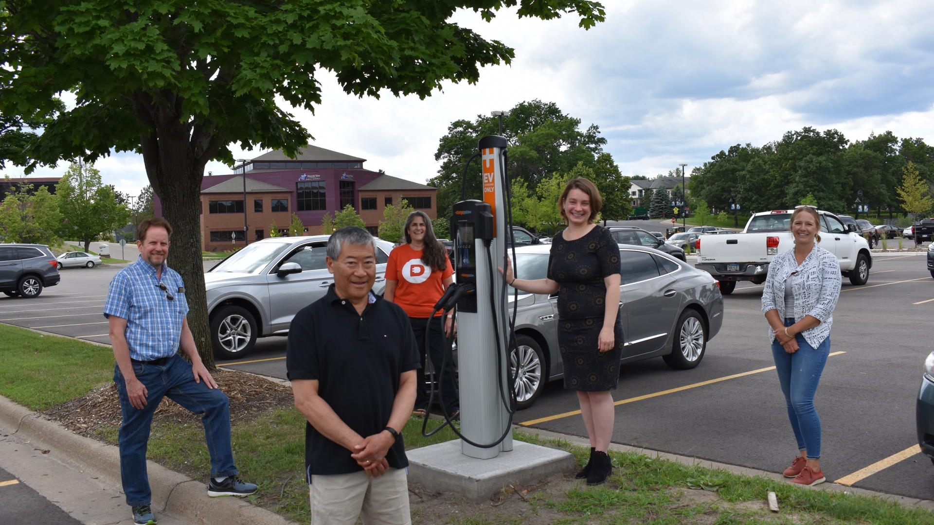 Team members gather around the new electric vehicle charging station developed in the city of Shoreview, Minnesota. Cummins employees contributed to the effort and are now working to create a charging station in the city of White Bear Lake (photo courtesy of the Great Plains Institute).