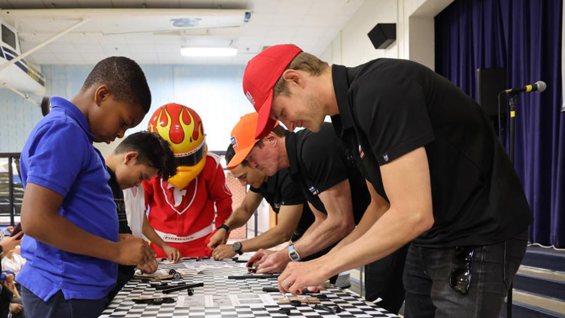 IndyCar drivers building cars with students