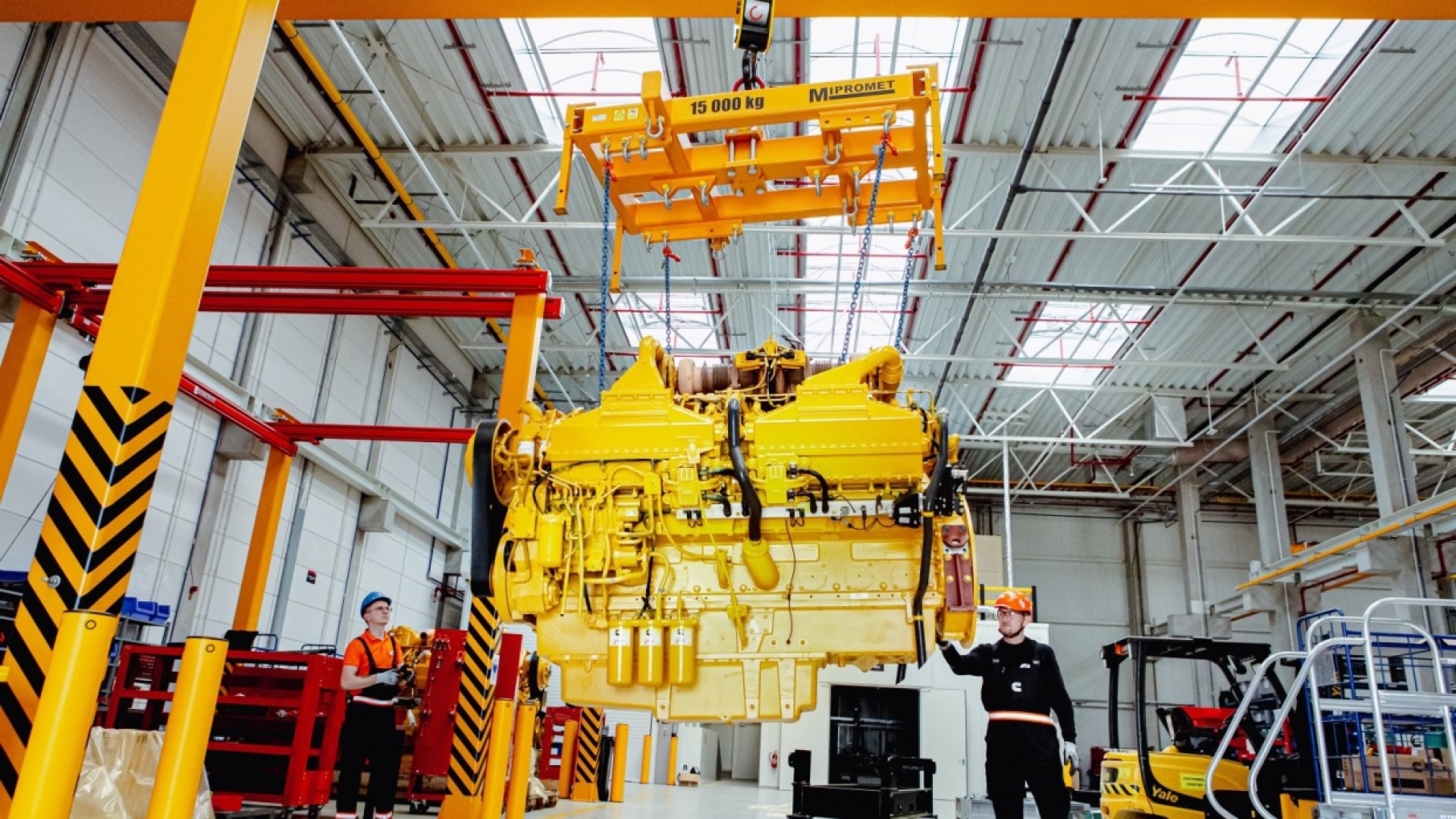 engine being hoisted up inside the rebuild center