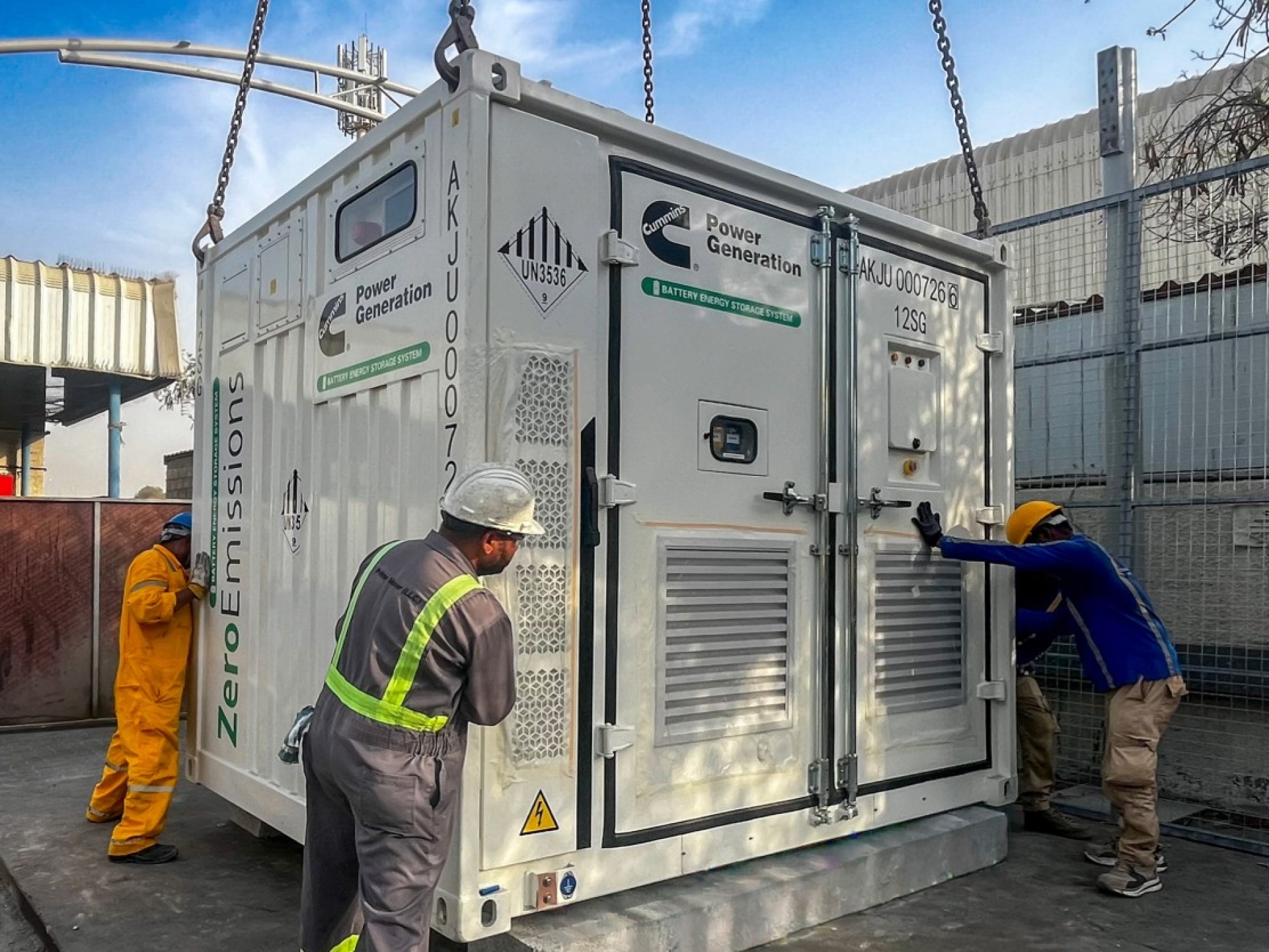 Battery Energy Storage System being put down from Crane with help of workers.