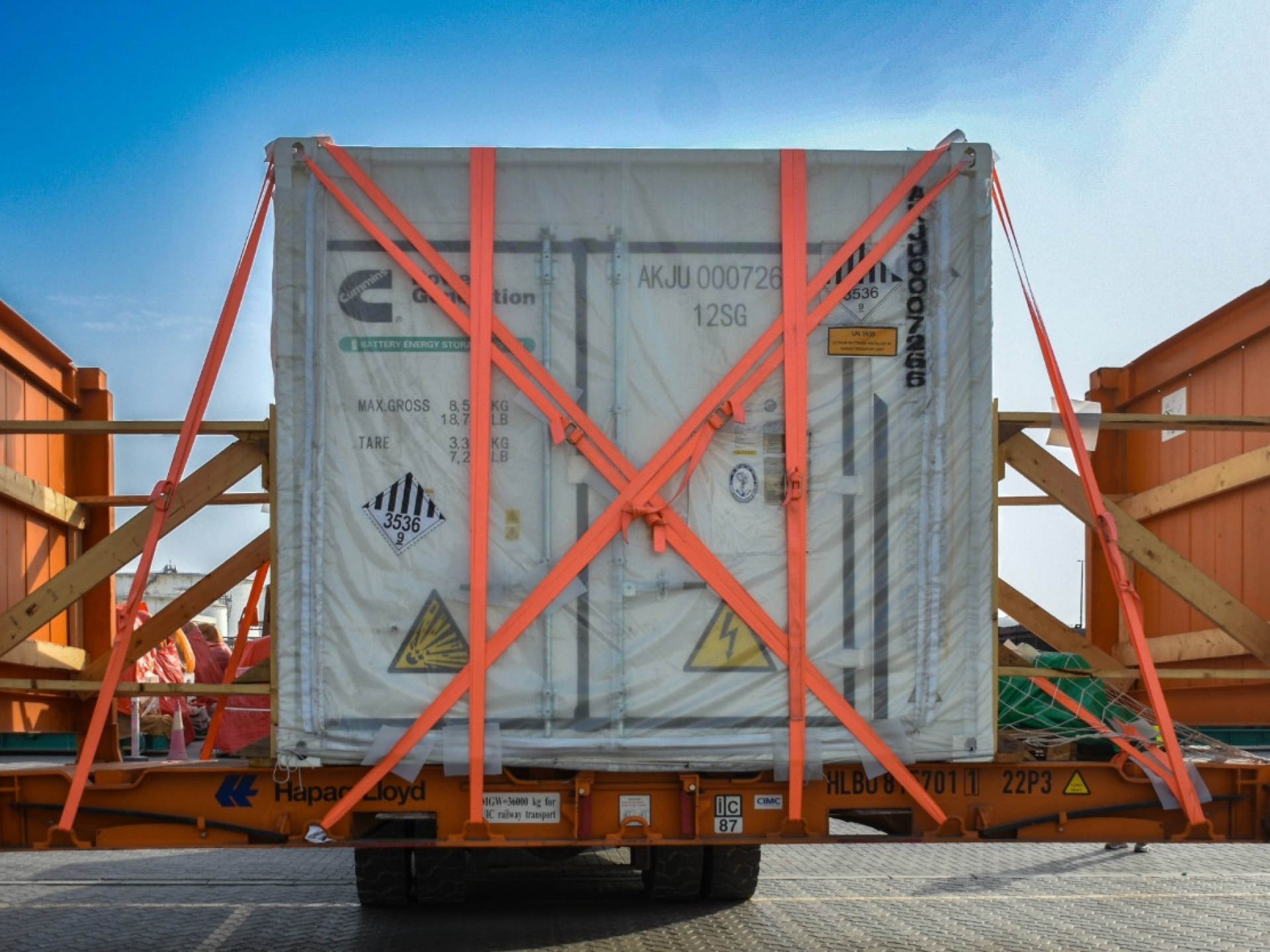 Battery Energy Storage System with safety straps around it as it's being hauled.