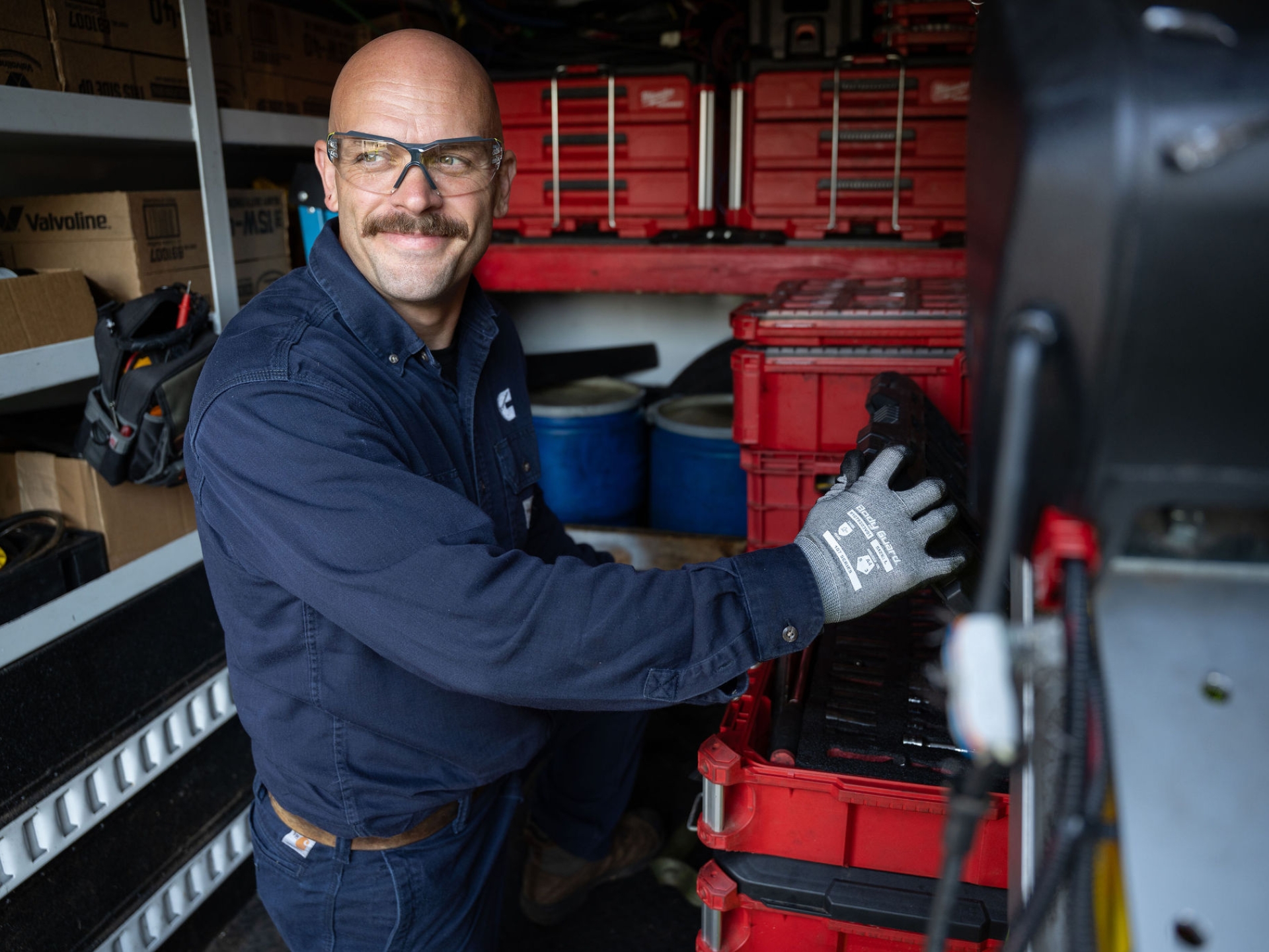 Field service technician organizing tools in a service truck