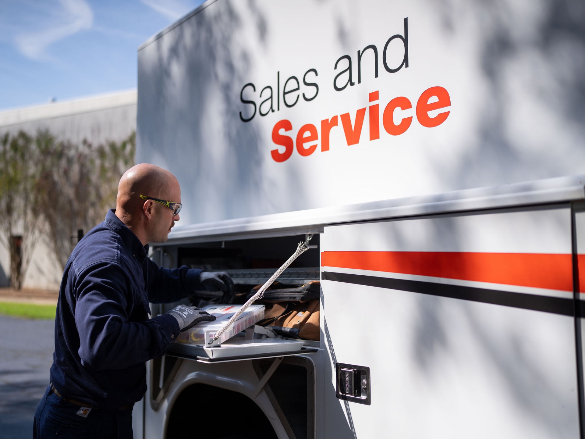 Cummins field service technician accessing tools from a service truck on-site