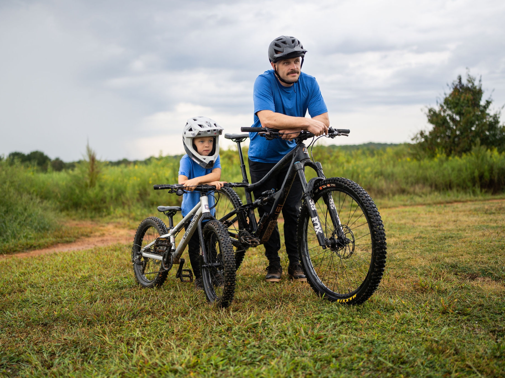 Father and son with bikes outdoors on a trail