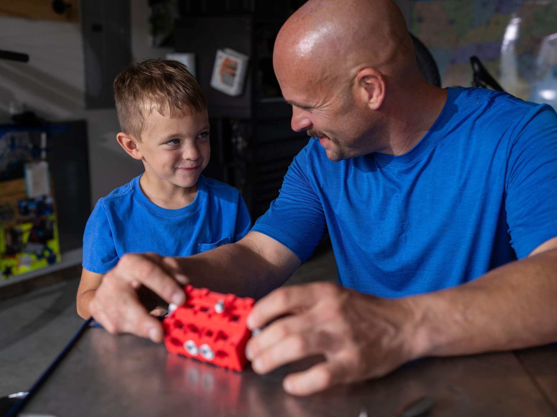 Father and son building a toy engine together