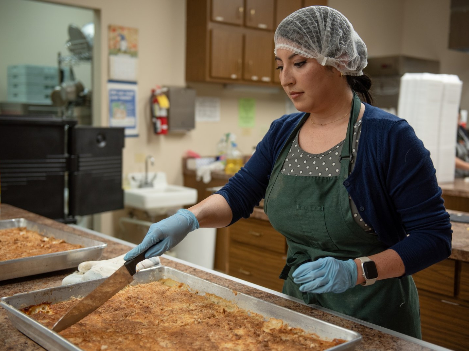 Amy helps package a Community Diner meal as part of Cummins community engagement.