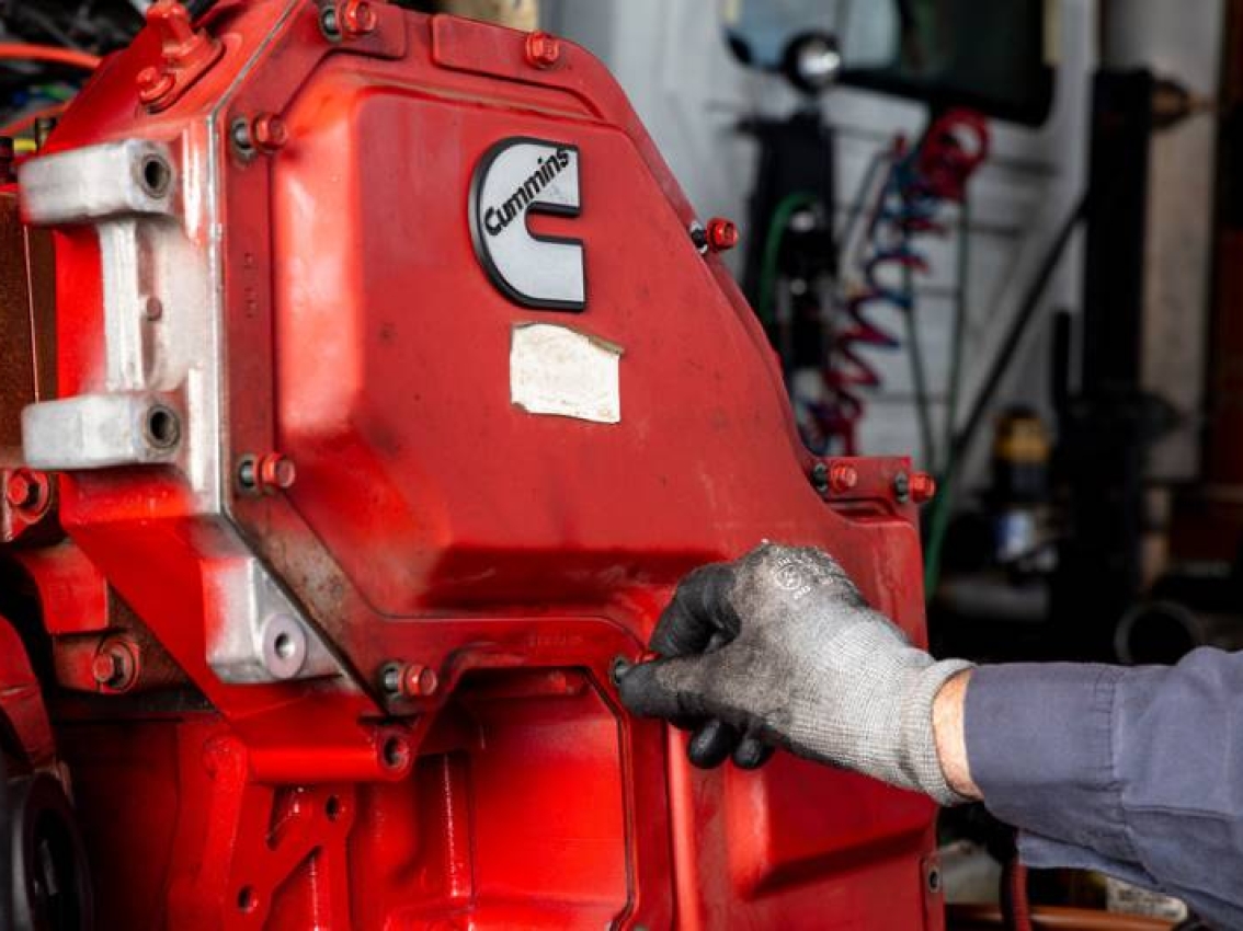 technician adjusting engine parts